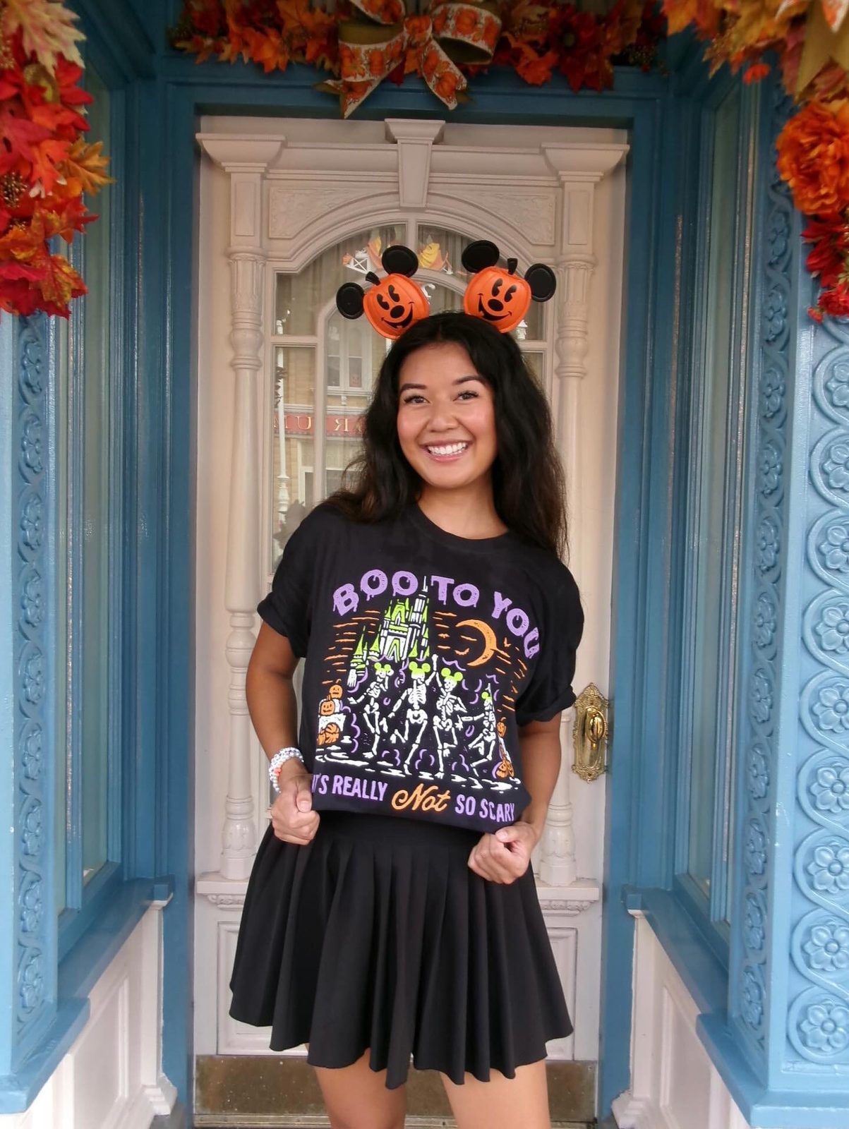 Women wearing a Not So Scary shirt,  a MNSSHP Inspired t-shirt with dancing skeletons and magic castle located in Magic Kingdom located at Disney World and Disneyland. It is part of the Boo To You Parade. 
