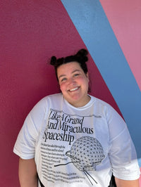 Girl  wearing the building your future Spaceship Earth Disney-Inspired tee at Epcot in front of the bubble gum wall