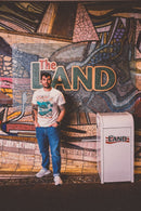 man wearing the landscapes of tomorrow Disney-Inspired tee in front of The Land ride at Epcot Disney World